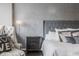 A spacious main bedroom featuring a stylish headboard, textured wallpaper and a small sitting area at 225 N New Jersey St # 52, Indianapolis, IN 46204