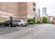 Parking lot with cars parked outside a building with city skyline views in the background at 225 N New Jersey St # 52, Indianapolis, IN 46204