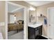 Cozy bathroom featuring a vanity with dark wood cabinets and a bedroom view, creating an inviting space at 2282 Creekland Dr, Columbus, IN 47201
