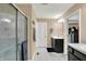 Bright bathroom with a glass-enclosed shower, vanity with black cabinets, and tile flooring creating a spa-like retreat at 2282 Creekland Dr, Columbus, IN 47201