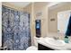 Bathroom featuring vanity, a patterned blue shower curtain, and a wall mirror at 2282 Creekland Dr, Columbus, IN 47201