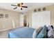 Cozy bedroom with a ceiling fan, double door closet, and large window creating a serene and inviting atmosphere at 2282 Creekland Dr, Columbus, IN 47201