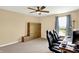 Comfortable bedroom featuring two office chairs, a ceiling fan, and a large window that provides natural light at 2282 Creekland Dr, Columbus, IN 47201