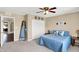 Tranquil bedroom featuring a ceiling fan, a cozy bed with blue pillows, and access to other rooms at 2282 Creekland Dr, Columbus, IN 47201