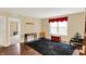 Versatile bonus room featuring hardwood floors, natural light from a large window, and charming decorative elements at 2282 Creekland Dr, Columbus, IN 47201