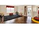 Open bonus room with hardwood floors, a large window, and unique decor, perfect for versatile use at 2282 Creekland Dr, Columbus, IN 47201