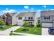 Inviting two-story home with a well-kept lawn, an attached garage, and a cozy front porch at 2282 Creekland Dr, Columbus, IN 47201