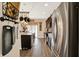 A kitchen with an island, stainless steel appliances, and hanging pot rack provides a culinary experience at 2282 Creekland Dr, Columbus, IN 47201