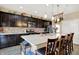 A spacious kitchen with stainless steel appliances, dark cabinetry, island with marble countertops, and hanging pot rack at 2282 Creekland Dr, Columbus, IN 47201