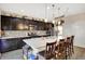 Well-lit kitchen with an island, breakfast bar, stainless steel appliances, and ample cabinet space at 2282 Creekland Dr, Columbus, IN 47201