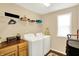 Functional laundry room with washer, dryer, storage cabinets and convenient shelving at 2282 Creekland Dr, Columbus, IN 47201
