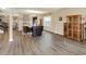 Open living area with modern flooring that connects seamlessly to an adjacent dining area and an open staircase at 2282 Creekland Dr, Columbus, IN 47201