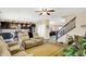 Inviting living room with recliners, a ceiling fan, and open access to kitchen and staircase at 2282 Creekland Dr, Columbus, IN 47201