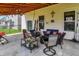 Charming covered patio with comfortable seating, ceiling fan, and decorative accents at 2282 Creekland Dr, Columbus, IN 47201