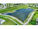Scenic aerial view of a large pond surrounded by lush green spaces and walking paths at 2282 Creekland Dr, Columbus, IN 47201