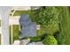 Aerial view of a home with a well-maintained lawn, mature trees, and a dark roof at 2463 Kettering Way, Indianapolis, IN 46214