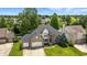 Aerial view of a two-story home with a lush lawn, mature trees, and two-car attached garage at 2463 Kettering Way, Indianapolis, IN 46214