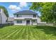 Well-maintained backyard featuring a freshly mowed lawn, privacy fence, and outdoor seating area at 2463 Kettering Way, Indianapolis, IN 46214