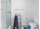 Bright bathroom with toilet, chrome towel rack, and glass shower doors at 2463 Kettering Way, Indianapolis, IN 46214