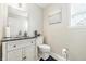 Bathroom featuring stylish sink with vanity, decorative mirror and adjacent toilet at 2463 Kettering Way, Indianapolis, IN 46214