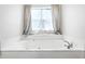 Relaxing bathroom featuring a large soaking tub with large window view at 2463 Kettering Way, Indianapolis, IN 46214