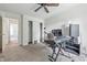 Bright bedroom featuring keyboard, desk, ceiling fan, carpet, and closet at 2463 Kettering Way, Indianapolis, IN 46214