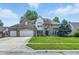 Charming two-story home with brick accents, lush landscaping, and a spacious driveway at 2463 Kettering Way, Indianapolis, IN 46214