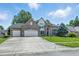 Traditional two-story home featuring a manicured lawn, brick facade, and an attached two-car garage at 2463 Kettering Way, Indianapolis, IN 46214