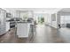 Eat-in kitchen features stainless steel appliances, black granite countertops, a breakfast bar, and views of the backyard at 2463 Kettering Way, Indianapolis, IN 46214