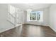 Bright and open living room features a chandelier, large window, and stairway to the second floor at 2463 Kettering Way, Indianapolis, IN 46214