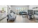 Bright living room featuring wood floors, neutral walls, a fireplace, and large windows at 2463 Kettering Way, Indianapolis, IN 46214