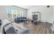 Cozy living room featuring a fireplace, laminate floors, and a window offering natural light at 2463 Kettering Way, Indianapolis, IN 46214