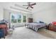 Spacious bedroom with a ceiling fan, carpet, and large windows offering plenty of natural light at 2463 Kettering Way, Indianapolis, IN 46214