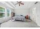 Spacious bedroom featuring ceiling fan, carpet, and a large window at 2463 Kettering Way, Indianapolis, IN 46214