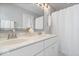 Bright bathroom featuring a dual sink vanity with white countertops and a shower with a white curtain at 2499 Blue Ridge Dr, Greenwood, IN 46143