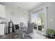 Bright dining area with a glass table, contemporary chairs, and sliding glass doors to the backyard at 2499 Blue Ridge Dr, Greenwood, IN 46143