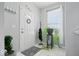 Bright entryway featuring neutral walls, decorative wreath, practical coat rack, and eye-catching houseplants at 2499 Blue Ridge Dr, Greenwood, IN 46143