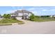 Inviting two-story home with a well-kept lawn, complemented by lush landscaping and a serene pond view at 2499 Blue Ridge Dr, Greenwood, IN 46143