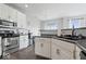Well-lit kitchen with white cabinets, stainless steel appliances, and a modern sink with dark countertops at 2499 Blue Ridge Dr, Greenwood, IN 46143