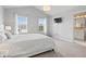 Airy main bedroom featuring a queen-sized bed, soft lighting, and a glimpse into the ensuite bathroom at 2499 Blue Ridge Dr, Greenwood, IN 46143