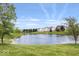 Scenic view of pond surrounded by lawn and homes in the distance at 2499 Blue Ridge Dr, Greenwood, IN 46143