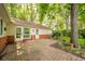 Backyard with brick patio that looks out onto the lawn with trees in the background at 2613 W Queensbury Rd, Muncie, IN 47304