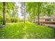Large backyard with well-maintained lawn and mature trees providing shade and privacy at 2613 W Queensbury Rd, Muncie, IN 47304