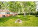 Expansive backyard featuring a well-manicured lawn, mature trees, and inviting outdoor space at 2613 W Queensbury Rd, Muncie, IN 47304