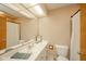 Well-lit bathroom with a large mirror, white vanity, and a combined shower and tub at 2613 W Queensbury Rd, Muncie, IN 47304