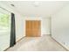 Spacious bedroom with soft carpet, a window, and a built-in closet, perfect for storage at 2613 W Queensbury Rd, Muncie, IN 47304