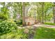 Charming single-story home with well-maintained landscaping and mature trees providing privacy at 2613 W Queensbury Rd, Muncie, IN 47304