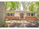 Inviting front entrance with brick accents and a well-maintained walkway at 2613 W Queensbury Rd, Muncie, IN 47304