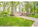 Single-story home with attached garage and beautiful green lawn and mature trees at 2613 W Queensbury Rd, Muncie, IN 47304