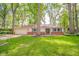 Charming single-story home with an attached garage, brick accents, and a lush green lawn at 2613 W Queensbury Rd, Muncie, IN 47304